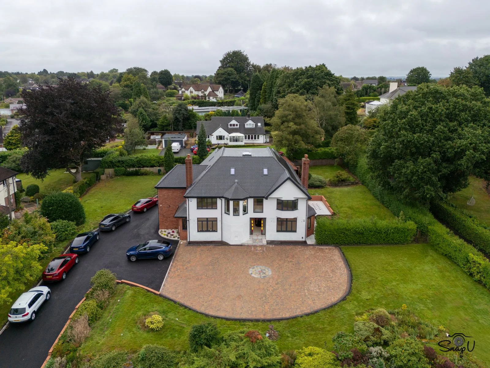 Aerial drone photograph of a luxury detached home and landscaped grounds for estate agent marketing UK