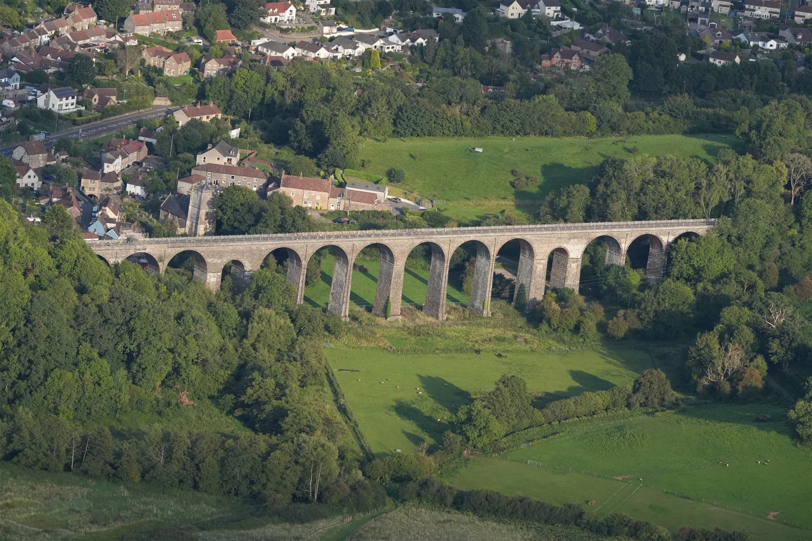 Aerial photograph of a historic rail viaduct crossing a rural valley