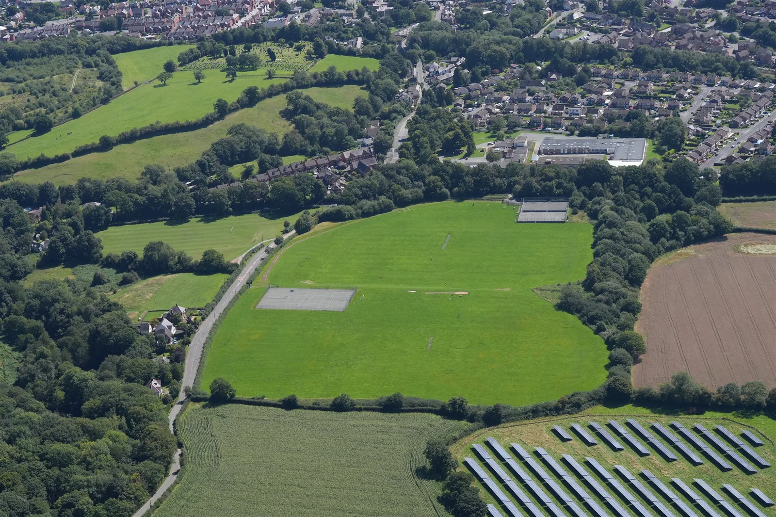 Aerial view of a solar farm beside rural fields
