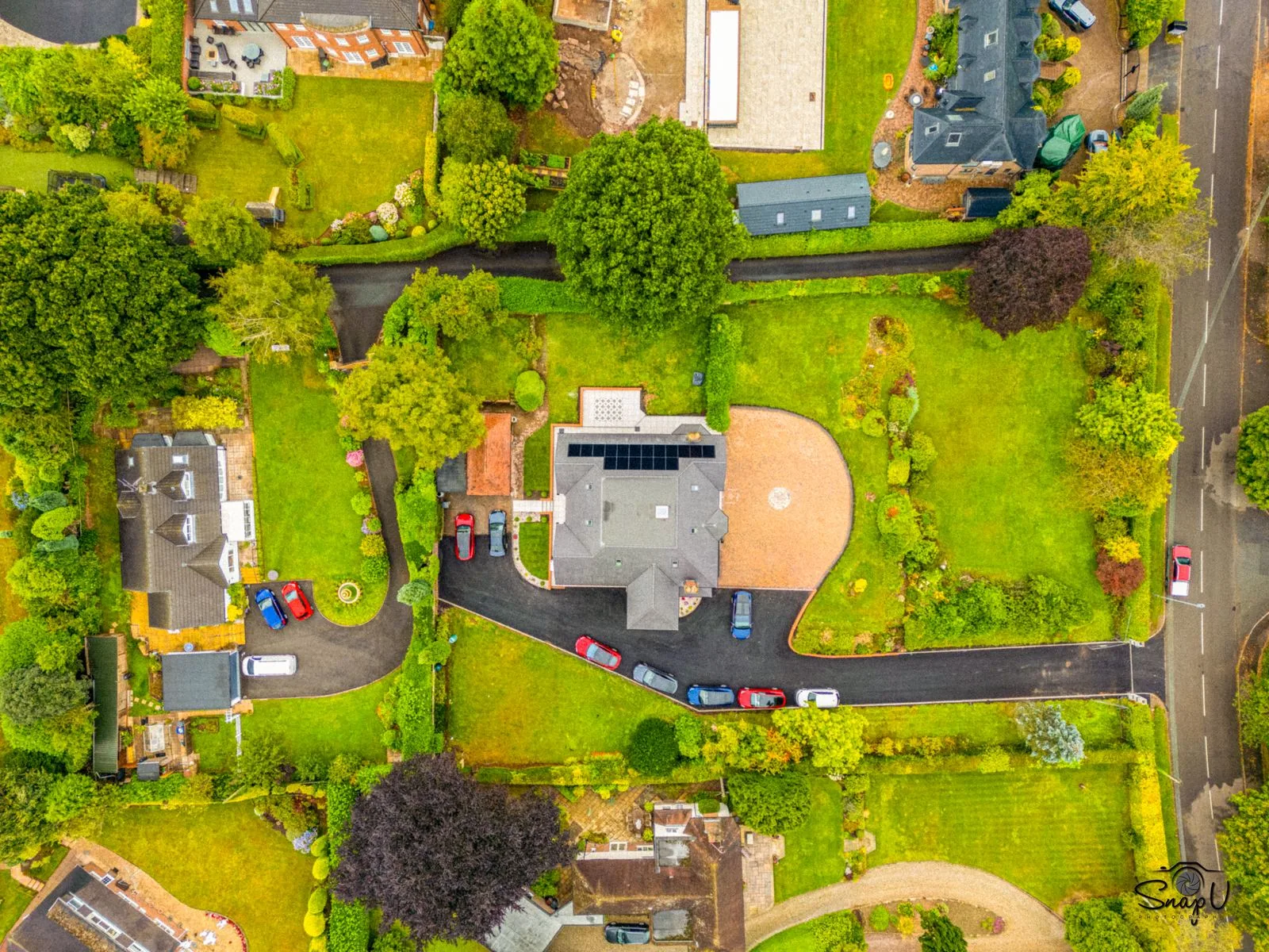Top-down aerial photograph showing a full property plot and its surrounding context